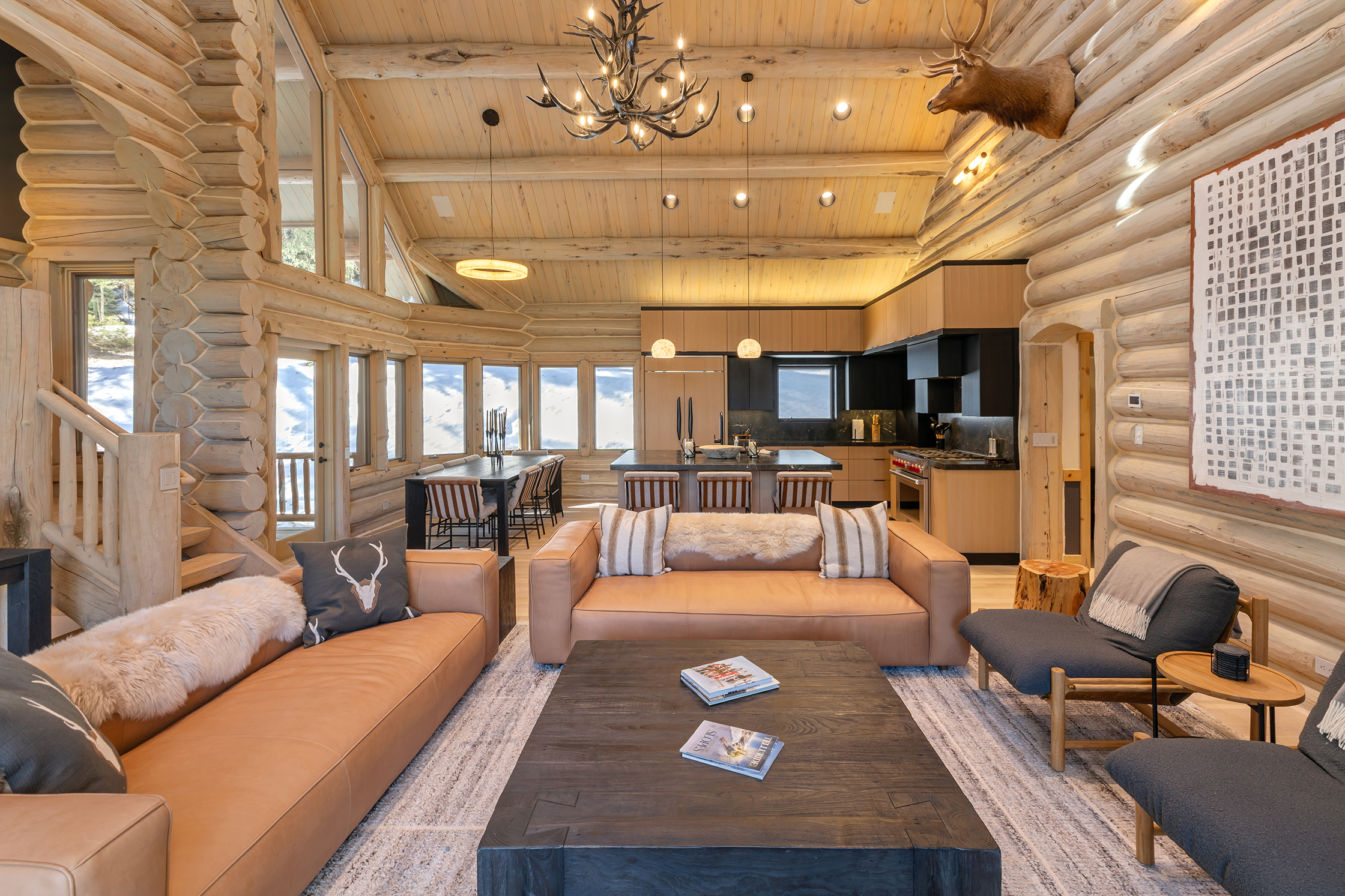 Great room with stone fireplace and vaulted ceilings at 107 Rocky Road, Mountain Village